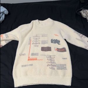 a white sweater with patterns size L